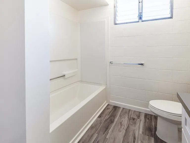 Bathroom featuring a built-in tub and modern fixtures.