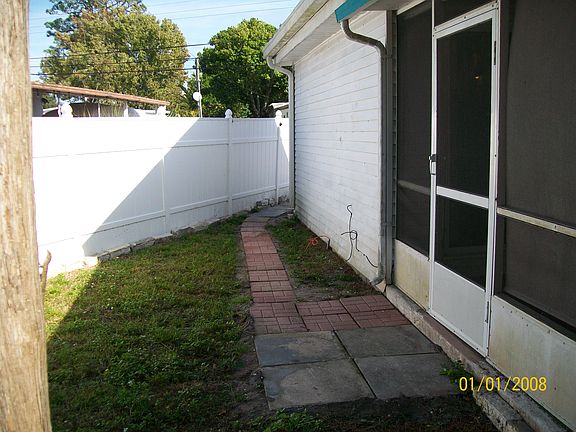 Rear Florida room entrance with walkway to rear parking