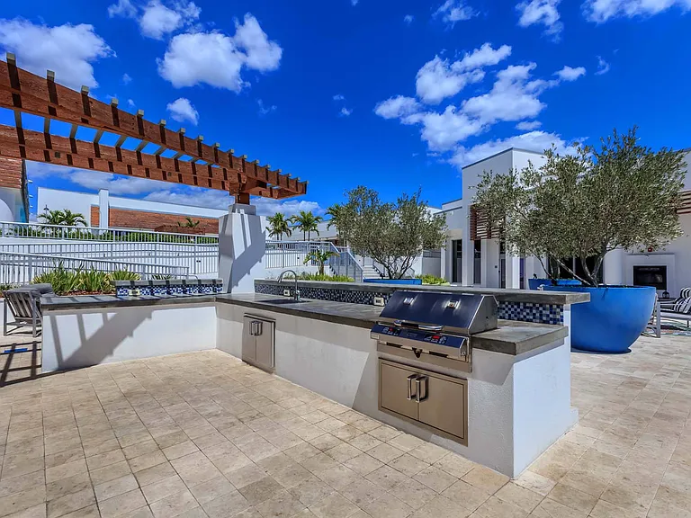 Cook and entertain with ease in your spacious outdoor kitchen, complete with a grill and sink for effortless al fresco dining.