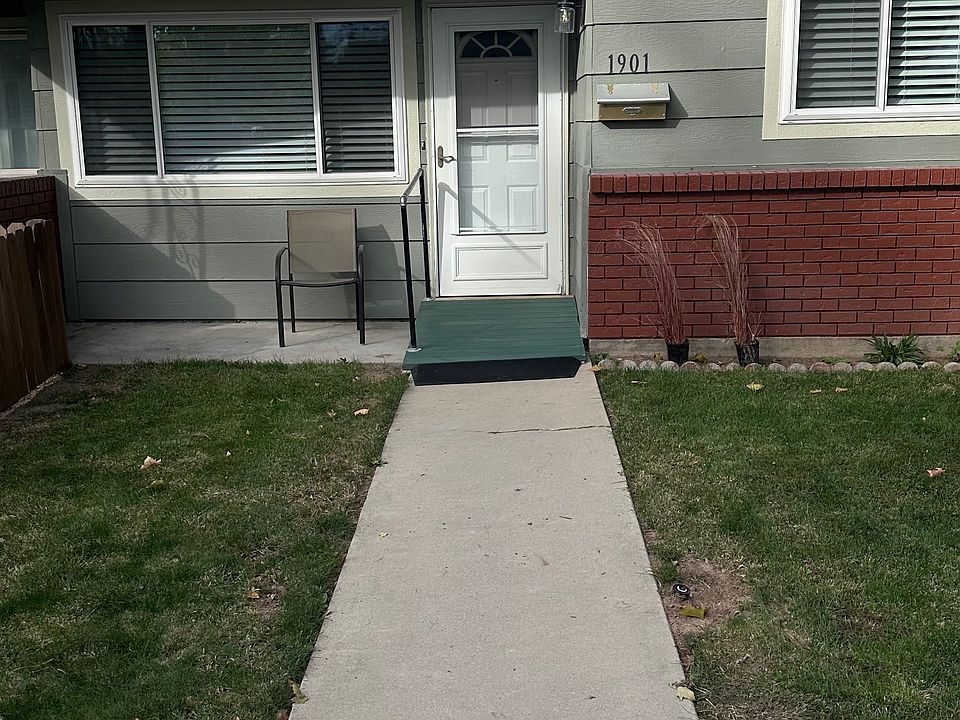 View of the front door with ramp, and grab bar for disabled individual.