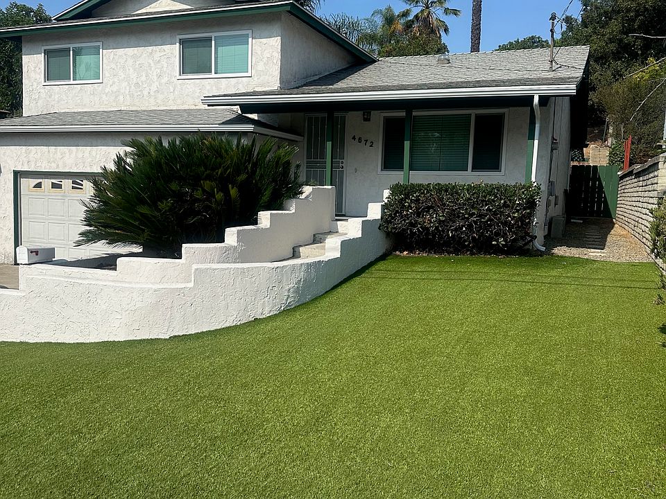 Front of house Yard with artificial turf Gate to backyard