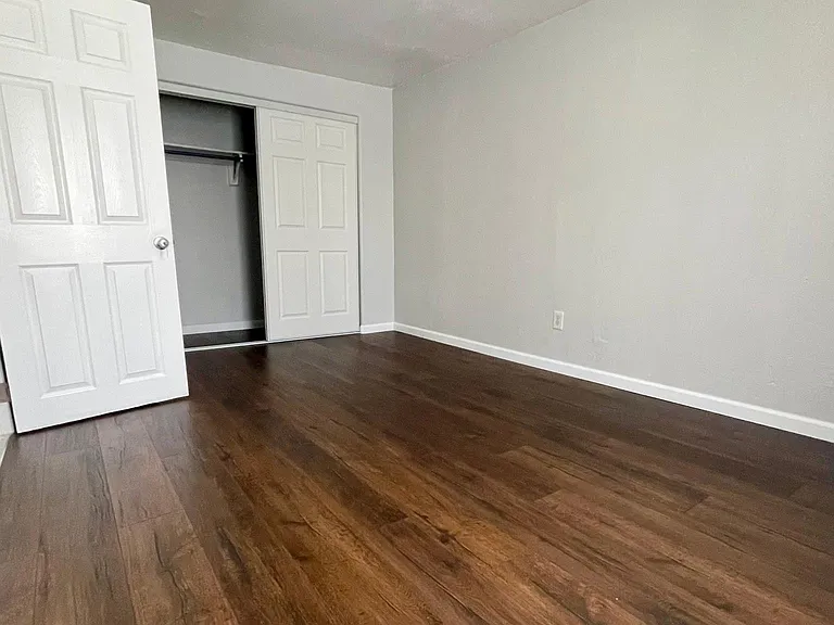 Master bedroom showing closet with sliding doors.