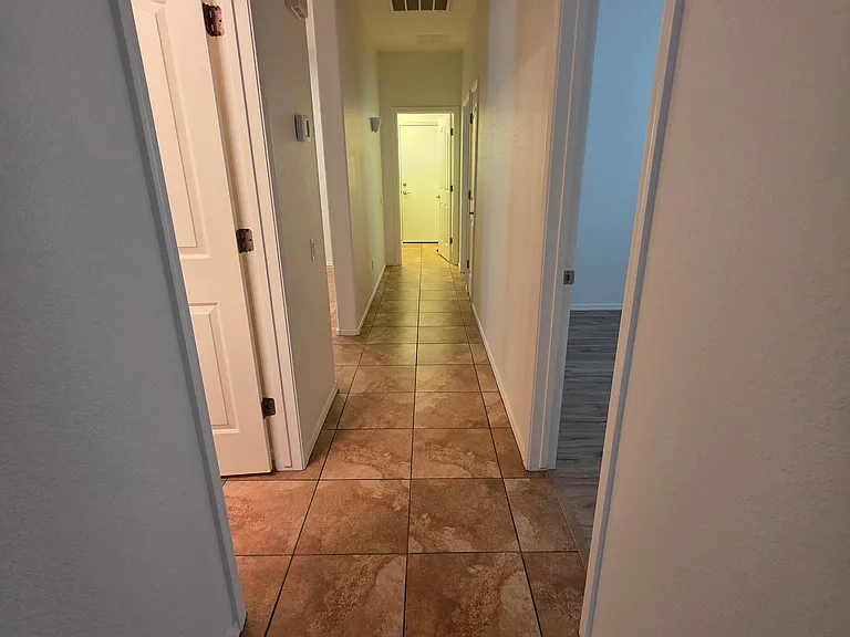 Hallway with three bedrooms on the right side, linen closet and second bathroom on the left side