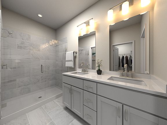 The primary bathroom offers dual vanity sinks and a walk-in shower.