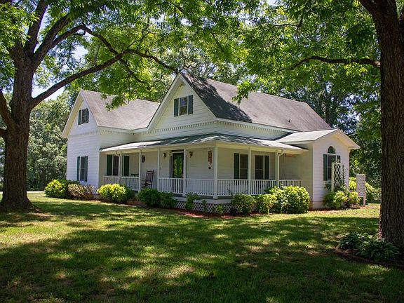 Right side of home-wraparound porch facing north and the barn area