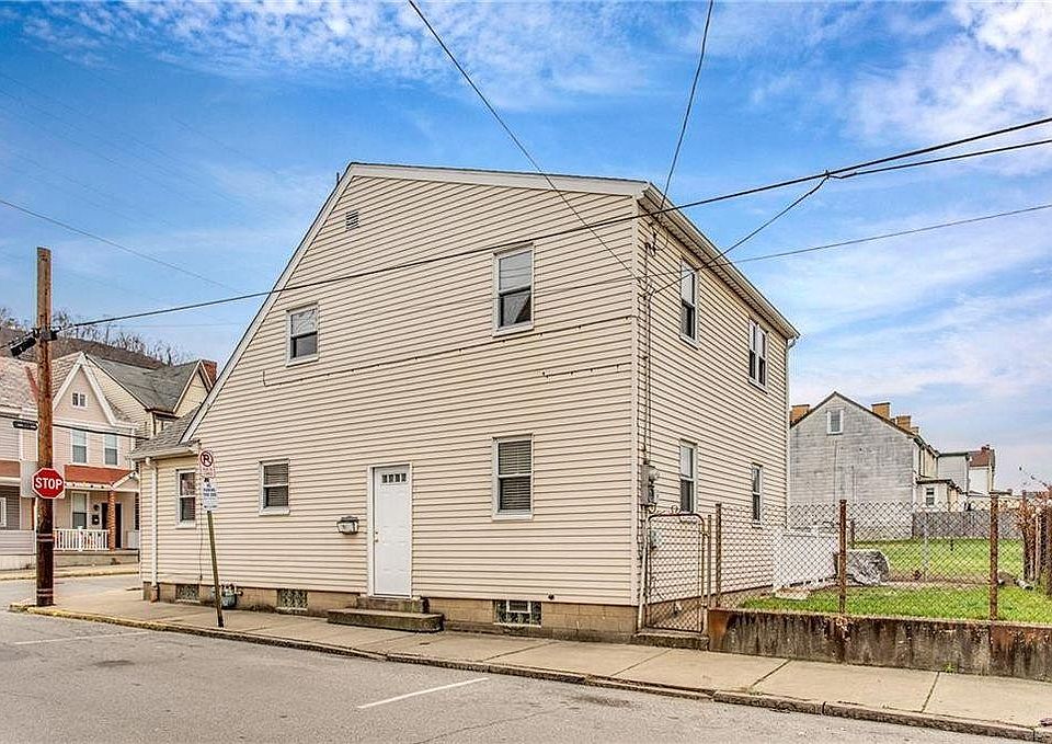 entrance to second floor apartment. Also shows yard on the side