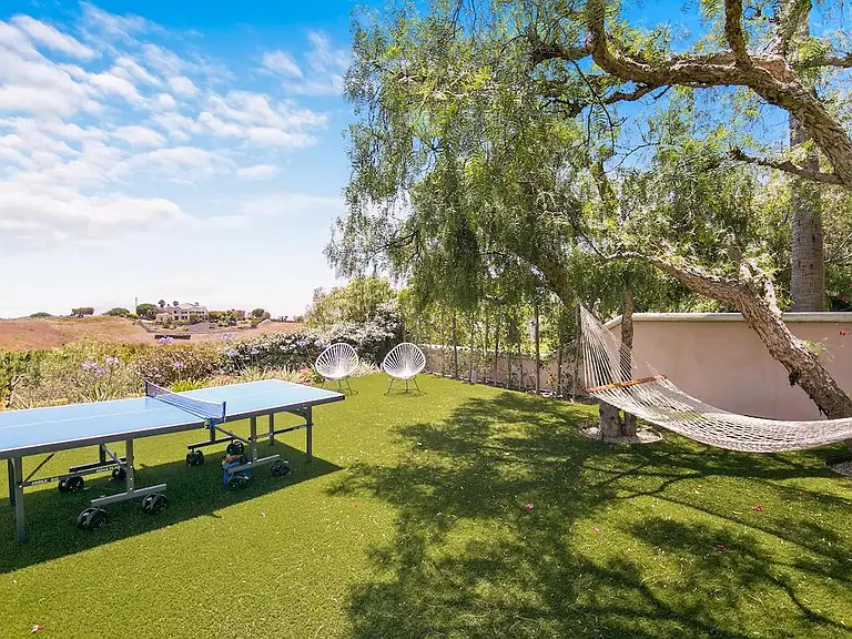 Ping pong table and hammock awaiting play and relaxation.