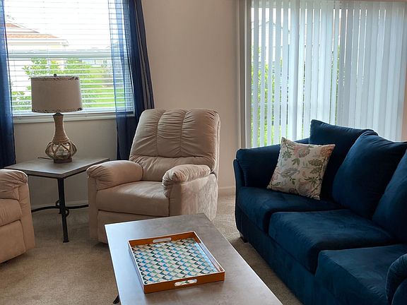 Living room. Couch and two recliners.