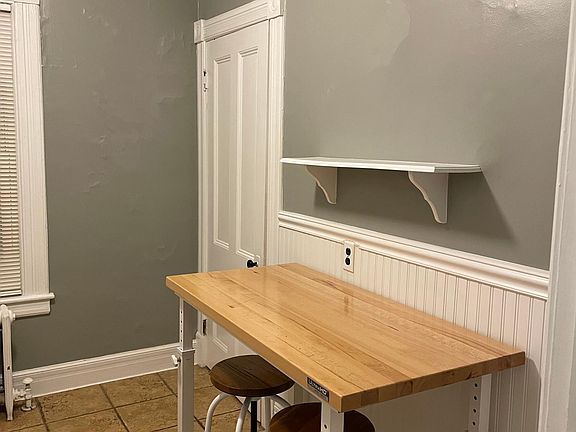 Butcher Block Adjustable Counter with Two Stools and Large Pantry Closet.