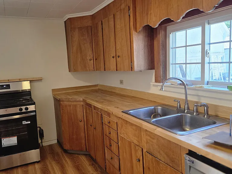 Kitchen With Lots Of Cabinet Space, New Butcher Block Countertop, New Stainless Steel Range, Refrigerator And Dishwasher & Premium Laminate Flooring