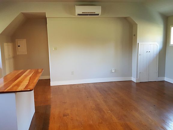 Large living/ dining room open to kitchen, with small but deep storage closet on right, coat closet on far left. Add your own barstools to the island for a great dining area.