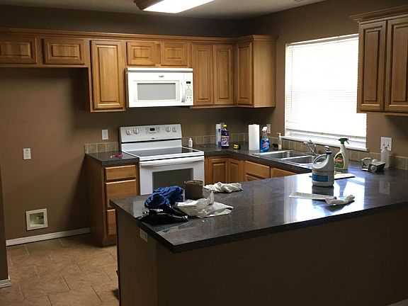 very functional kitchen with range, mico, dishwasher