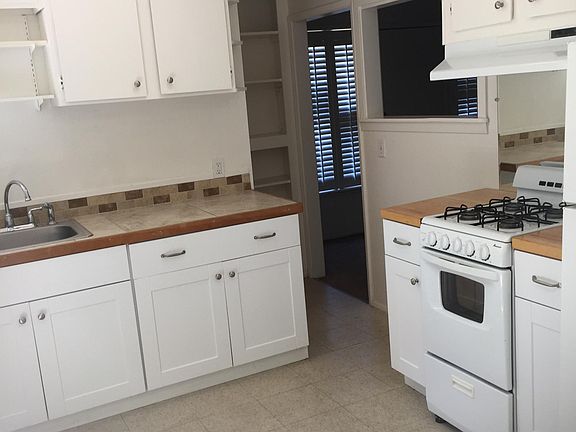 Gas stove, tiled and butcher block counter tops