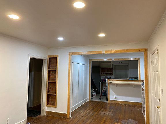 Living Room and Dining Rooms with Kitchen View; bedrooms and bathroom to the left