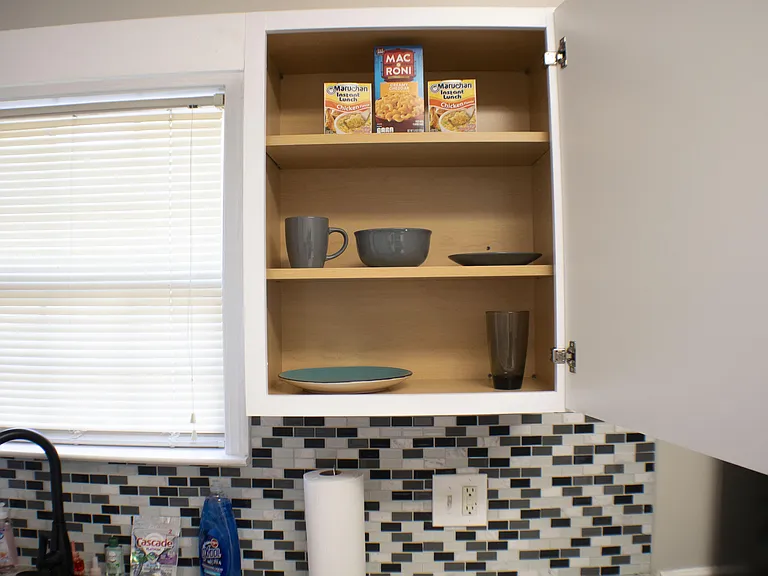 Kitchen labeled Cabinets with supplies