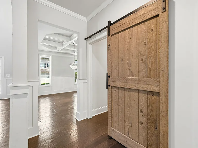 Oversized main level laundry accented with sliding barn door
