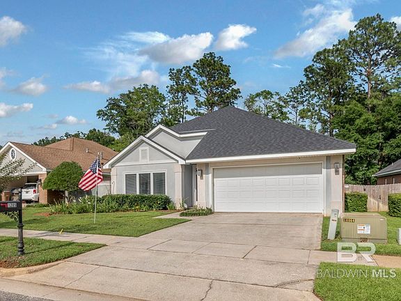 View of front of property with a garage and a front yard