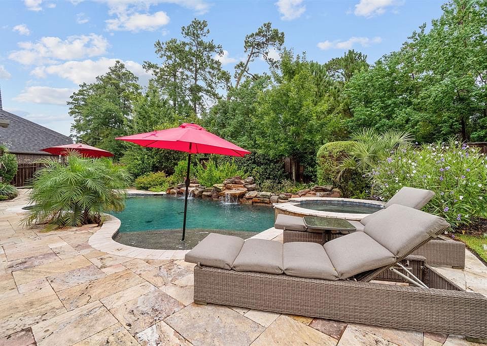 This yard has it all: privacy, outdoor kitchen, mature landscaping, waterfall, outdoor shower, multiple sitting areas garden and green space!