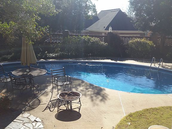 Enclosed backyard with private, built-in pool and bathhouse