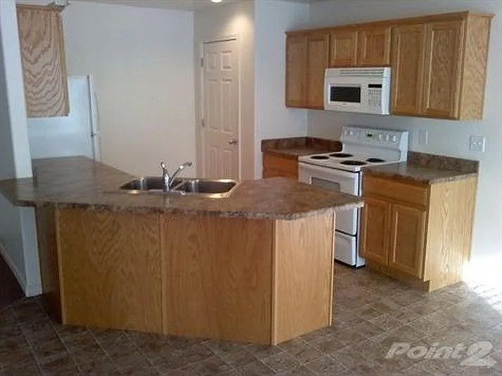 Kitchen with pantry door, microwave and stove