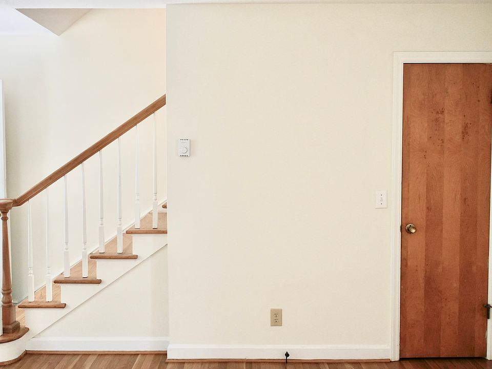 Living room closet, front door and stairs