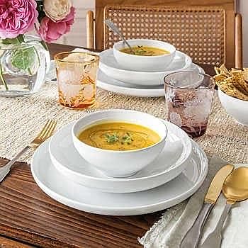 Set of 8 dishes, glasses and utensils. Kitchen is equipped with knives, pots and pans, cutting board and cooking utensils including a small coffee maker.