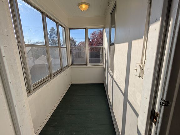 Back porch/sun room with south facing windows, skyline views.