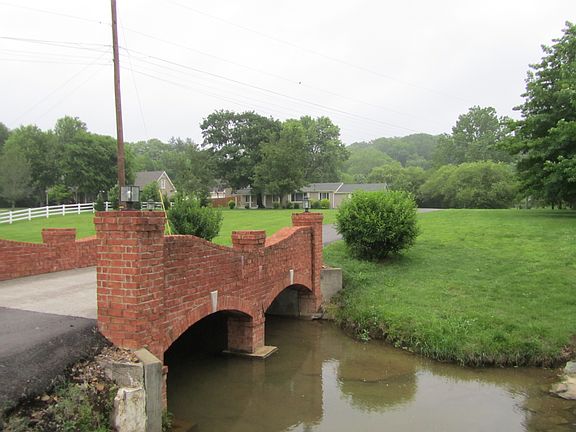 Stunning lighted bricked bridge entry.