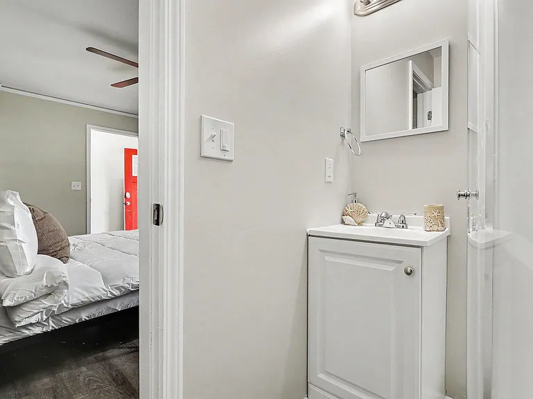 Full bathroom features a vanity with storage, mirrored medicine cabinet, and a tub/shower combo for easy daily routines.
