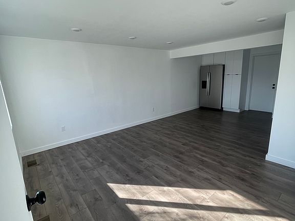 Spacious open-concept living and dining area with recessed lighting and natural light throughout.