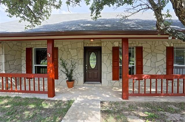 Beautiful white stone on all sides of this classic ranch. Mature oaks all around,