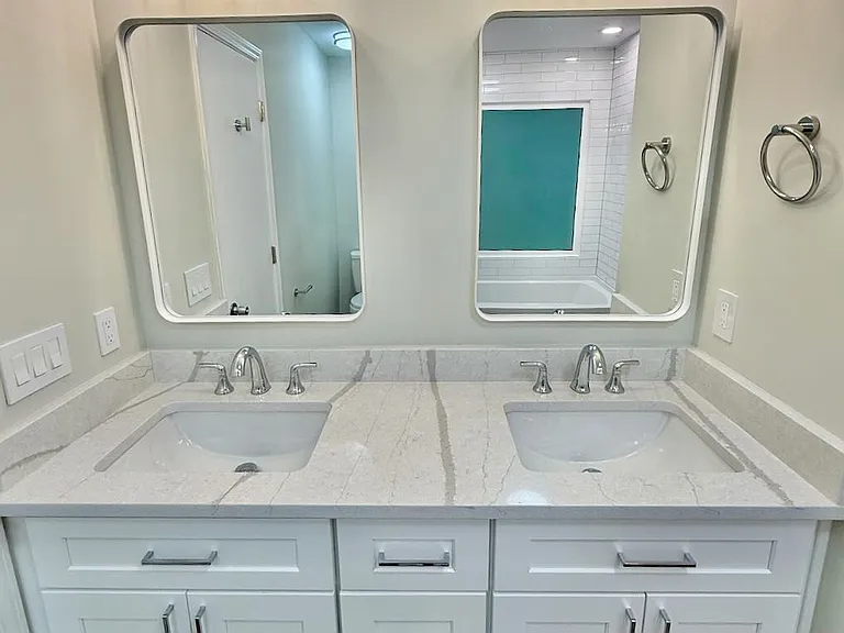 Spa-inspired oasis_ dual quartz-topped vanities with smart storage keep mornings organized. New modern lighting & wood-look floors create a serene retreat after busy days.