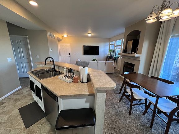 Cozy kitchen, dining area, and living room with well thought out layout.
