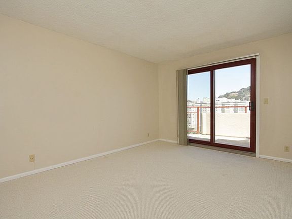 Bedroom with new Berber carpet & patio door leading to private deck
