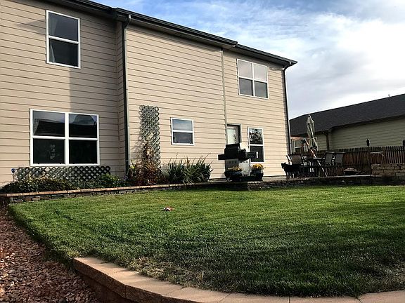 Backyard with garden, patio, firepit.