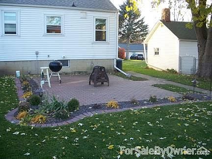 Brick patio lined with perrenials.