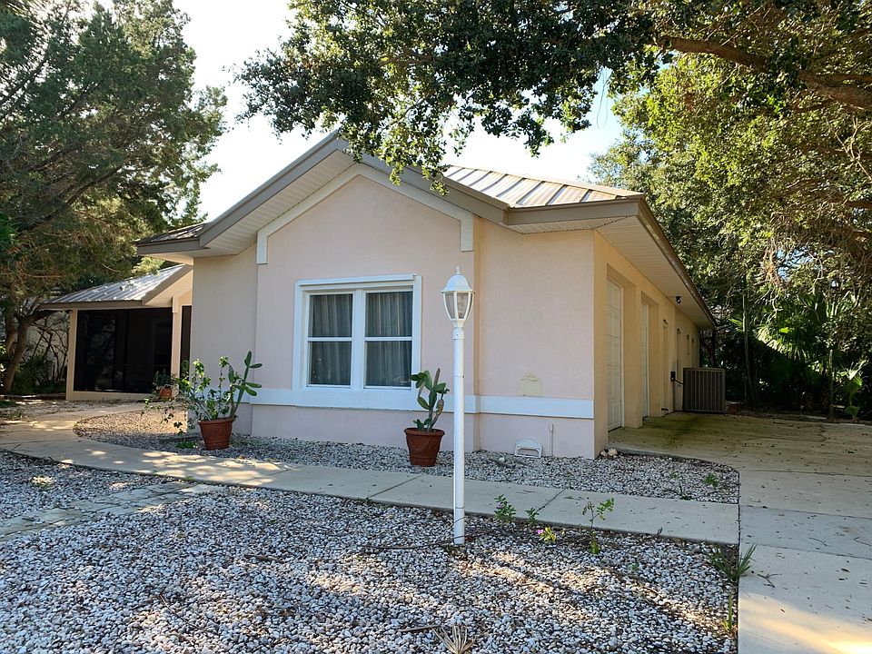 Side entry 2-car garage, metal roof, screened front porch.