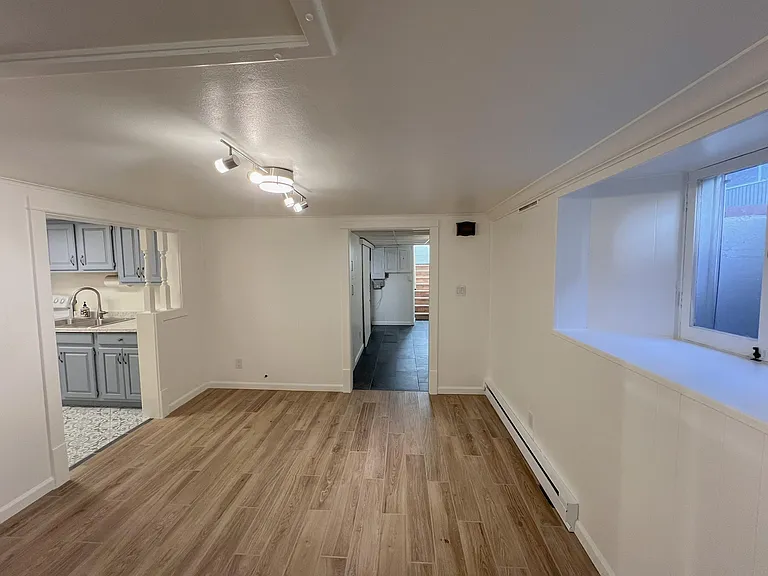 Living room facing entryway and kitchen