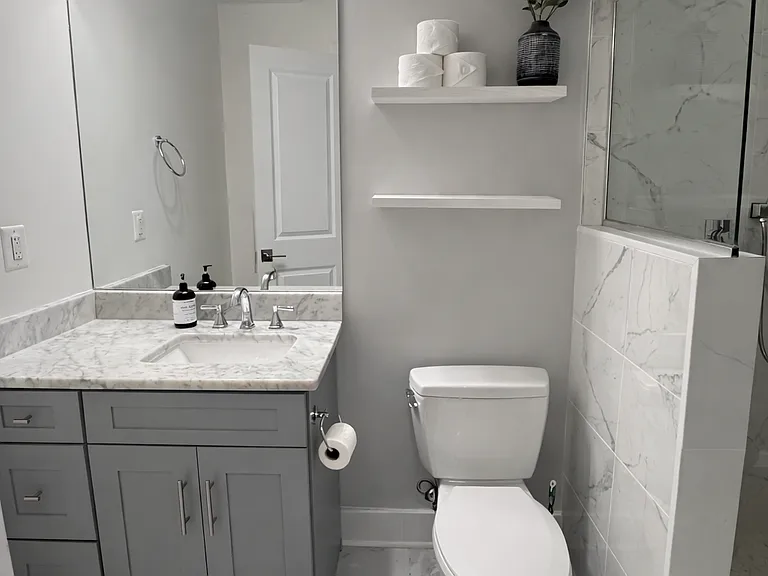 The primary bathroom includes a waterfall shower