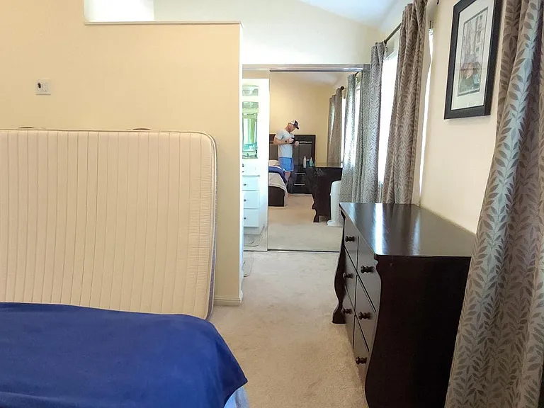 Master bedroom with carpets before which have now been replaced with wooden flooring
