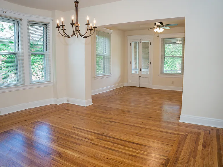 The living room has the double doors that lead to the private balcony