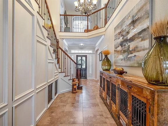 Looking back at the front door, you can appreciate how much natural light is reflected into the large foyer / gathering area to greet your guests. With additional storage and a secret door to storage under the stairs.