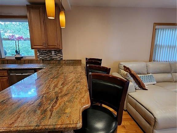 Oversized counter with seating and pendant lights.