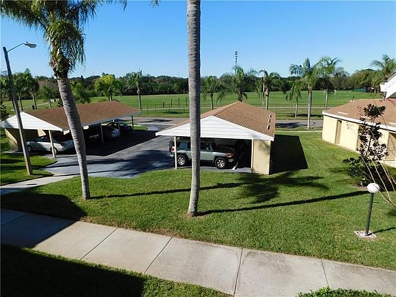View of front patio - carport front and center conveys with unit