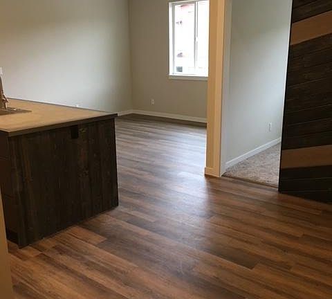 office located off of the living room has a sliding barn door