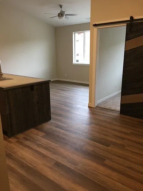 office located off of the living room has a sliding barn door