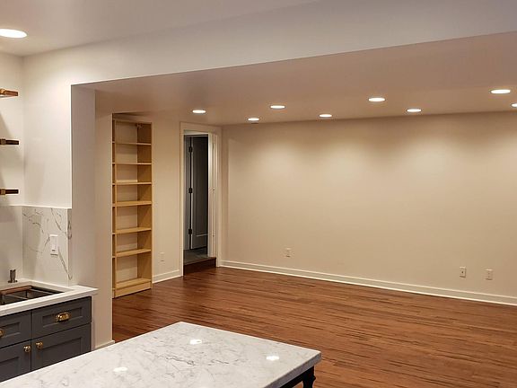 Living area from kitchen, with view of door to bedroom and laundry room