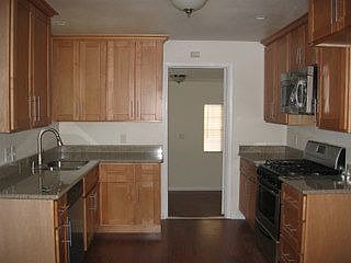 Kitchen with stainless appliances and granite slab counters