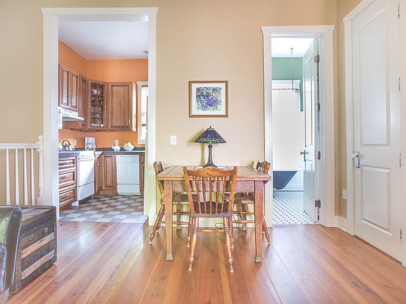 View of the dining table looking into the kitchen and bath.