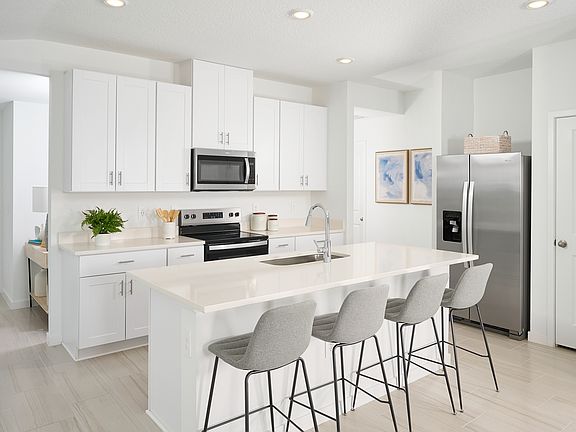 The Acadia floorplan kitchen modeled at Flagler Village.
